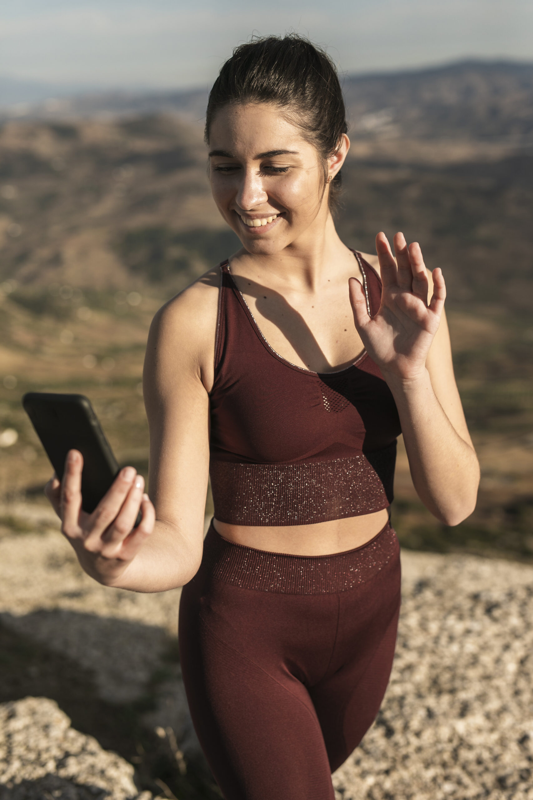 high-angle-young-woman-talking-video-call-phone